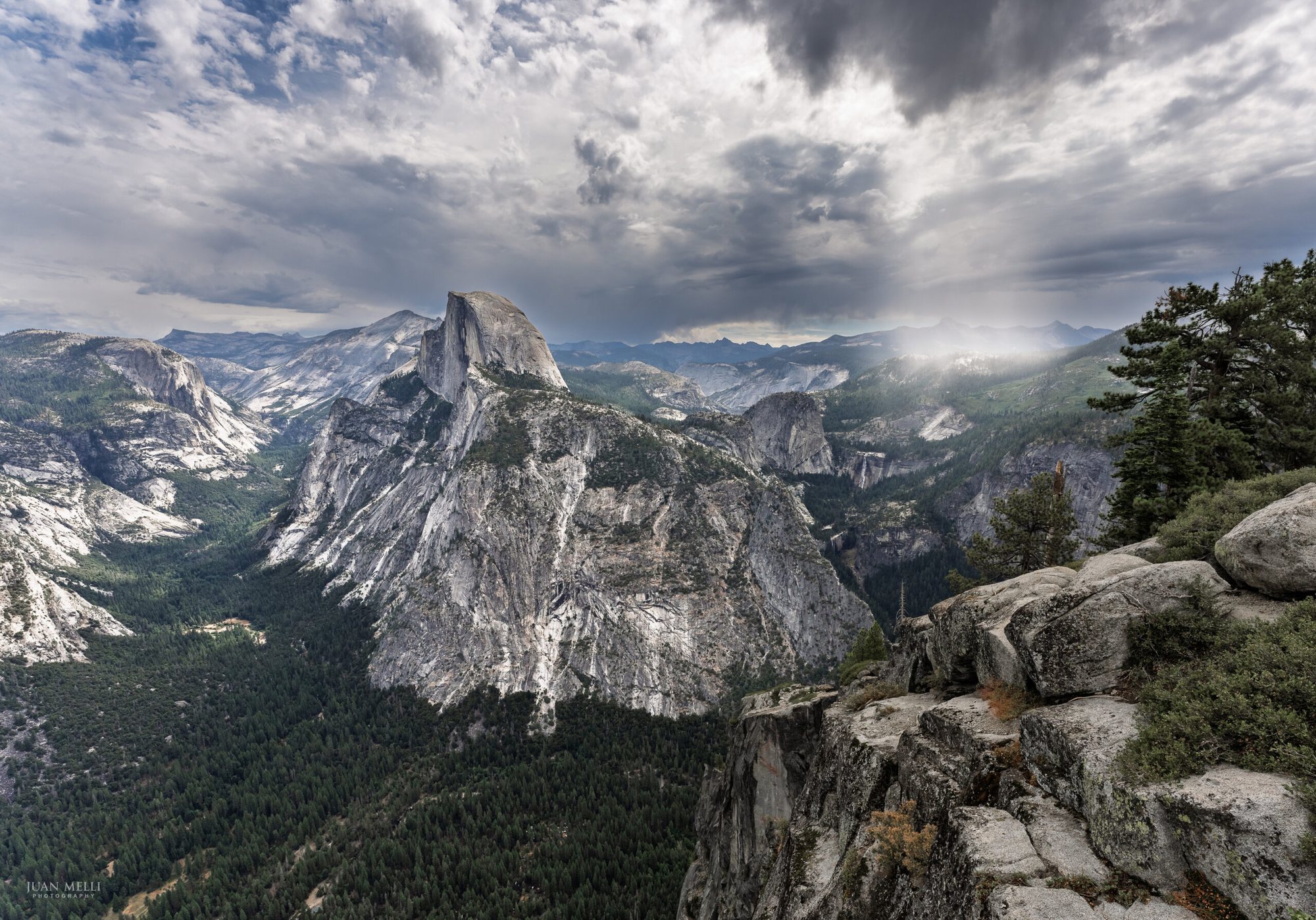 Half Dome towers over Yosemite Valley as storm clouds sweep across Yosemite’s high country.