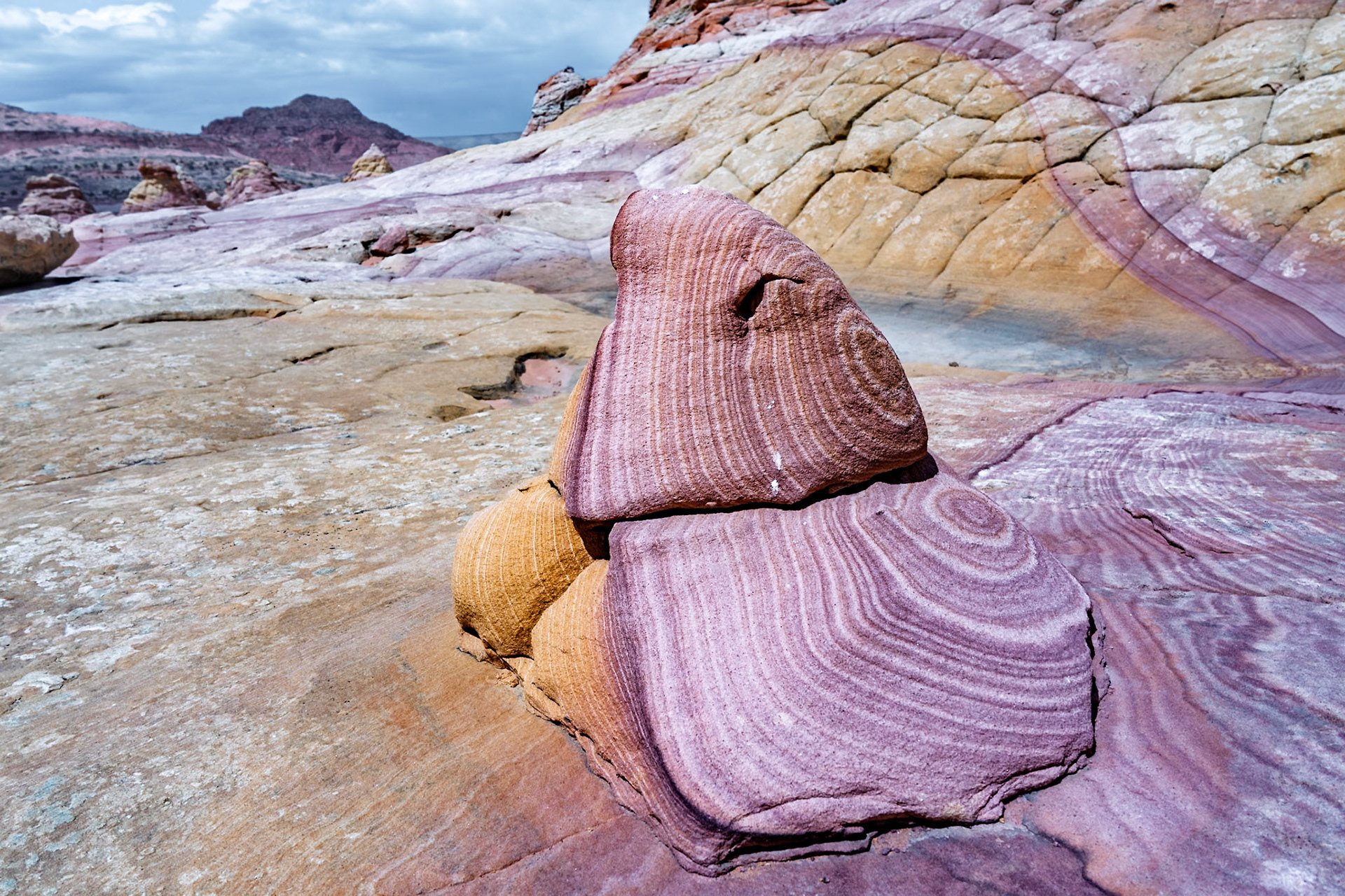 A striped pink sandstone formation in the desert