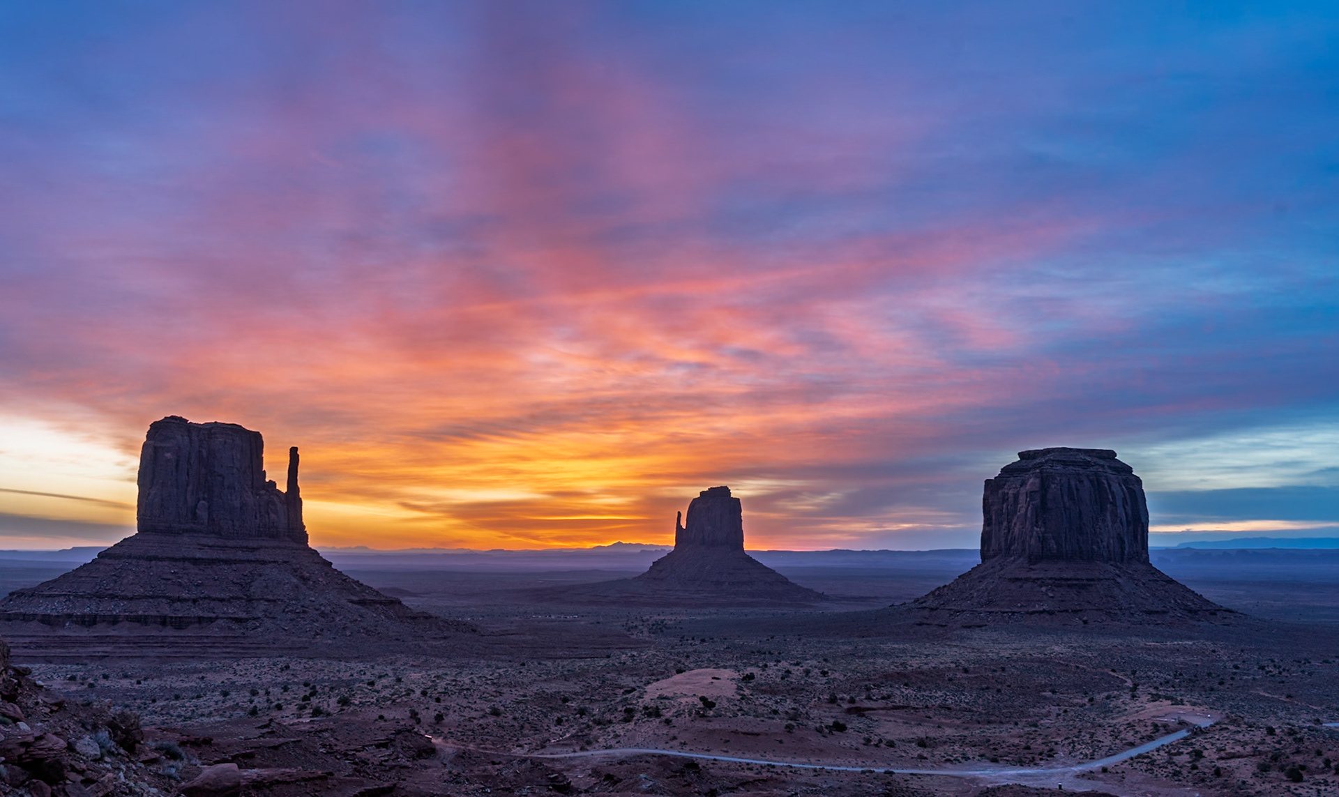 The Mittens and Merrick Butte in Monument Valley at sunset