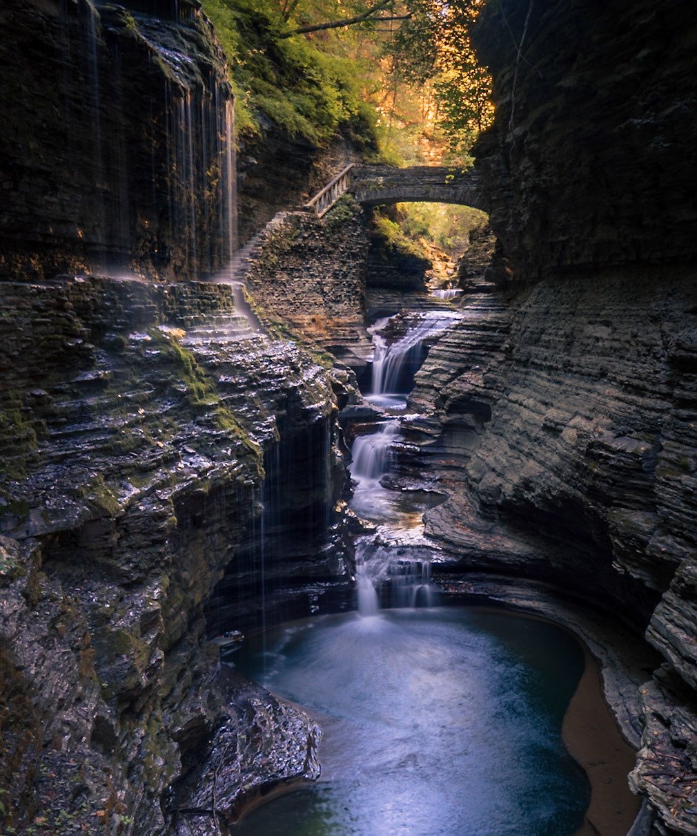 A stone bridge and waterfall in the narrow gorge of Watkins Glen